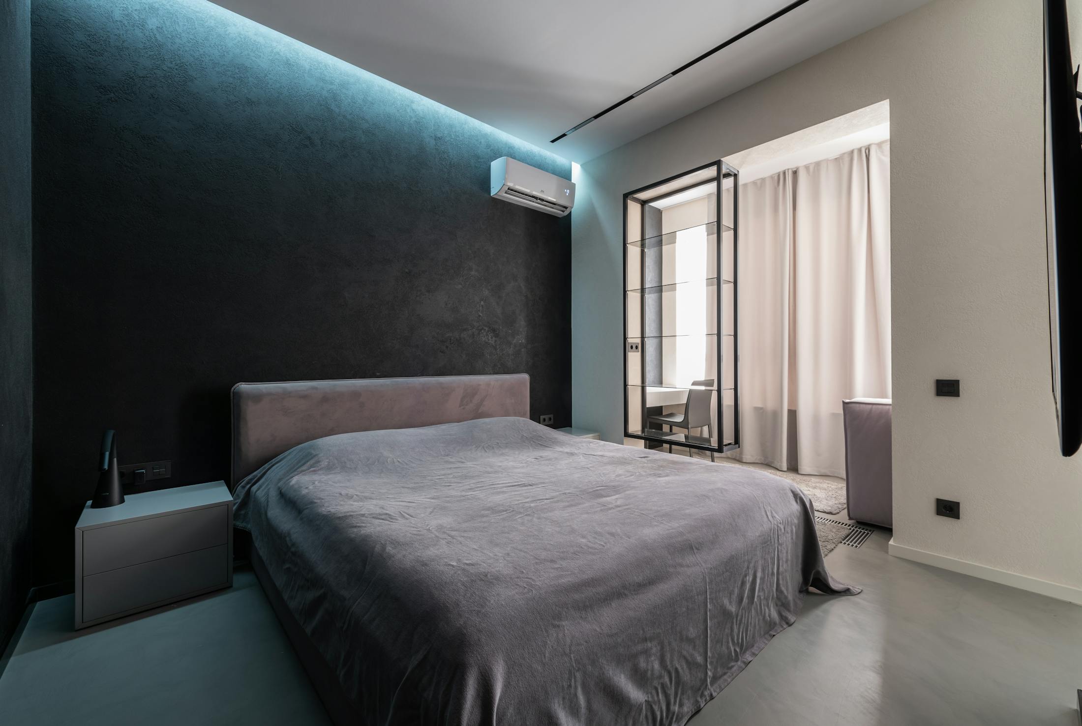 Elegant bedroom with discreet wall mounted air conditioning